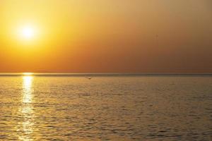 Beautiful sunrise over the sea. Natural orange background. Seascape. Copy space. photo