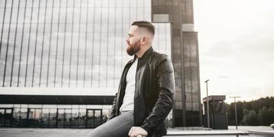 young stylish man in leather jacket photo