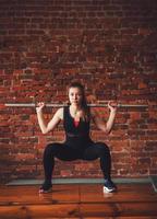 woman squats with barbell photo