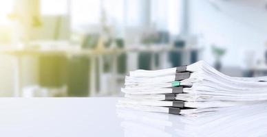 stack of reporting paper documents on a business table in the office, business documents for annual reports. Business analytics. Business office concept, soft focus. photo