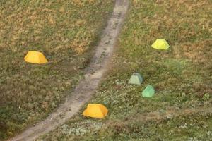 View from the top and camping with tourist tents against the backdrop of nature photo