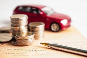 Car on coins money, saving bank, finance, installment payment, car loan interest.