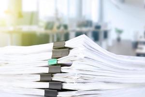 stack of reporting paper documents on a business table in the office, business documents for annual reports. Business analytics. Business office concept, soft focus. photo