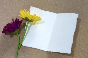 Torn paper on wooden surface and sunflower flat lay with copy space. photo