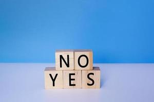 Yes and No on wooden cube. Decision, choosing and answer concept. photo