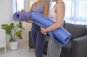 Fit young woman holding yoga mat, sport and healthy lifestyle concept.