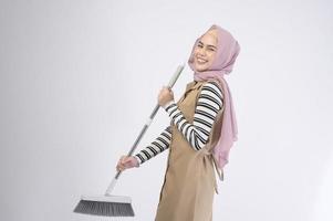 Young muslim beautiful housewife smiling on white background photo