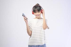 Young beautiful woman wearing headset on white background photo