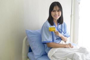 A young patient woman is holding credit card , admitting in hospital , Health care  concept photo