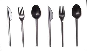 Repeating black plastic disposable knife,spoon and fork isolated on white, top view. photo