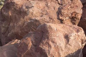 Brown mountain sandstone with large chunks of patterns, designed to be like nature by heavy machinery, beautifully crafted in a vast lakeside garden, perfect for relaxing and watching nature in summer photo