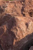 Brown mountain sandstone with large chunks of patterns, designed to be like nature by heavy machinery, beautifully crafted in a vast lakeside garden, perfect for relaxing and watching nature in summer photo