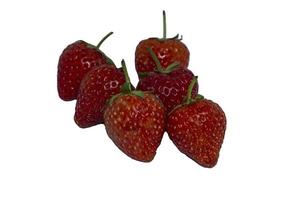 Delicious and ripe red strawberries are organic fruit on white background. Shot with flash and LED lights, images look sharp in my home studio on a separate white background. photo