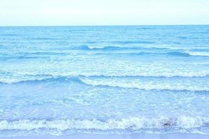 strong wind and ocean waves hit the shore. In the evening, the sea floor was blue, alternating with the grit of sand for a period that nature created, beautiful and scary. photo