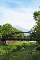 Beautiful Fuji mountain with wooden bridge cloud and blue sky in summer, the famous landmark and attraction place of tourists who have a long holiday in Japan, Lake Kawaguchiko photo