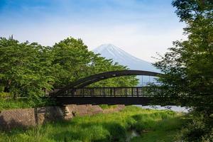 Beautiful Fuji mountain with wooden bridge cloud and blue sky in summer, the famous landmark and attraction place of tourists who have a long holiday in Japan, Lake Kawaguchiko photo