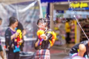 Songkran Festival or Songkran is celebrated in Thailand as the traditional New Year's Day from 13 to 15 April. People getting soaked during Songkran. photo