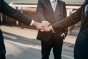 Businessman in suit handshake together for successful in city and walking people background. photo