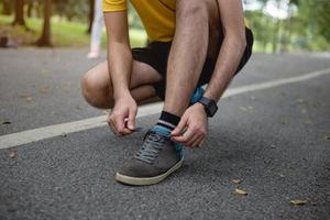 Runner trying running shoes getting ready for run. Healthy lifestyle.In the park photo