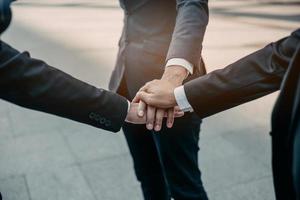 Businessman in suit handshake together for successful in city and walking people background. photo