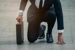 Asian businessman ready to run. Asian business person ready to run toward the city. Business opportunity concept photo