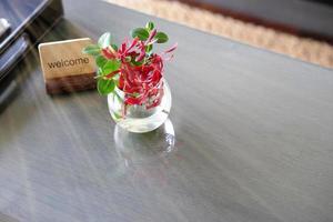 Welcome label stand with flower water vase on table for welcome reception concept photo