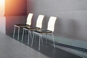 wooden and metal chairs on walkway for resting photo