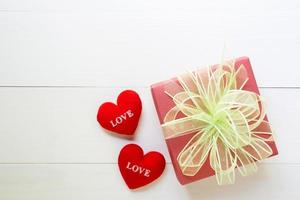 Holiday of gift box with bow ribbon on wooden white table, present of day on wood, vintage retro tone, 14 February of love day with romantic copy space, valentine concept, top view. photo