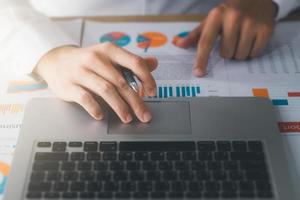 Businessman analyzing company's financial balance sheet working with digital augmented reality graphics. Businessman calculates financial data for long-term investment. photo