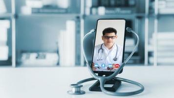 Concepts of online medicine, communicating with patients through online networks, technology and healthcare. Make a video call with a doctor on your smartphone. photo