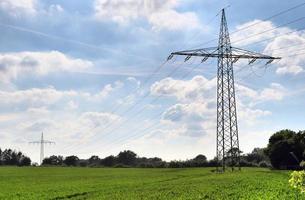 Close up view on a big power pylon transporting electricity in a countryside area photo