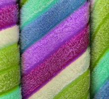 Detailed close up view on samples of cloth and fabrics in different colors found at a fabrics market photo