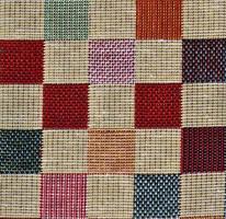 Detailed close up view on samples of cloth and fabrics in different colors found at a fabrics market photo