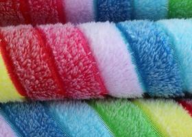 Detailed close up view on samples of cloth and fabrics in different colors found at a fabrics market photo