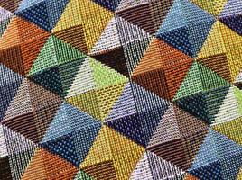 Detailed close up view on samples of cloth and fabrics in different colors found at a fabrics market photo