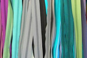 Detailed close up view on samples of cloth and fabrics in different colors found at a fabrics market photo
