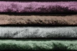 Detailed close up view on samples of cloth and fabrics in different colors found at a fabrics market photo