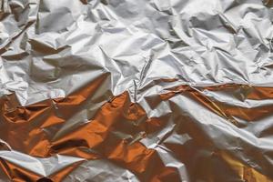 Detailed close up texture of an aluminum foil surface in different colors. photo