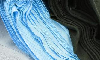 Detailed close up view on samples of cloth and fabrics in different colors found at a fabrics market photo
