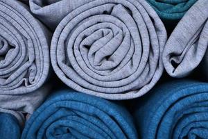 Detailed close up view on samples of cloth and fabrics in different colors found at a fabrics market photo