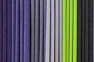 Detailed close up view on samples of cloth and fabrics in different colors found at a fabrics market photo