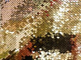 Close up view on samples of sequin fabric in golden colors photo
