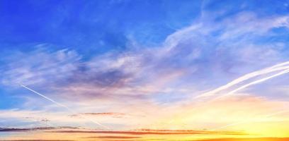 Beautiful high resolution panorama of orange and red sunset clouds in the evening sky photo