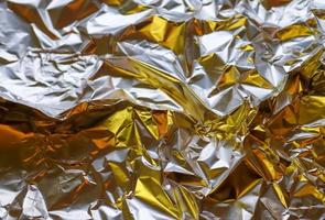 Detailed close up texture of an aluminum foil surface in different colors. photo