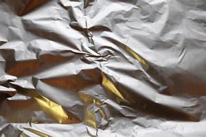 Detailed close up texture of an aluminum foil surface in different colors. photo