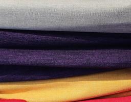 Detailed close up view on samples of cloth and fabrics in different colors found at a fabrics market photo
