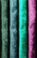 Detailed close up view on samples of cloth and fabrics in different colors found at a fabrics market photo