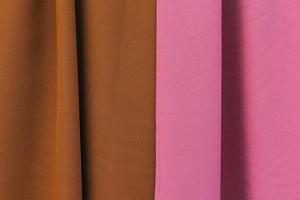Detailed close up view on samples of cloth and fabrics in different colors found at a fabrics market photo