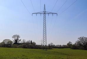 Close up view on a big power pylon transporting electricity in a countryside area