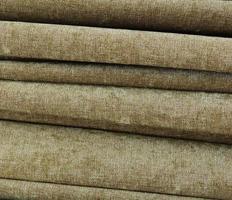 Detailed close up view on samples of cloth and fabrics in different colors found at a fabrics market photo
